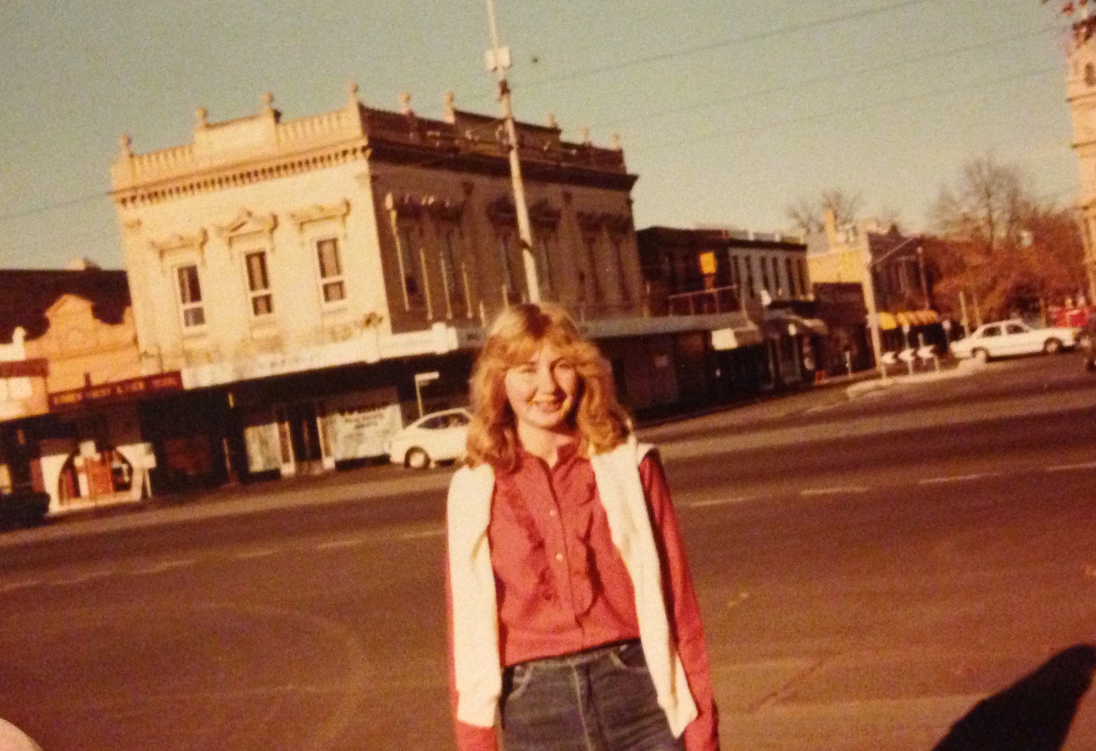 Young woman in red shirt in town