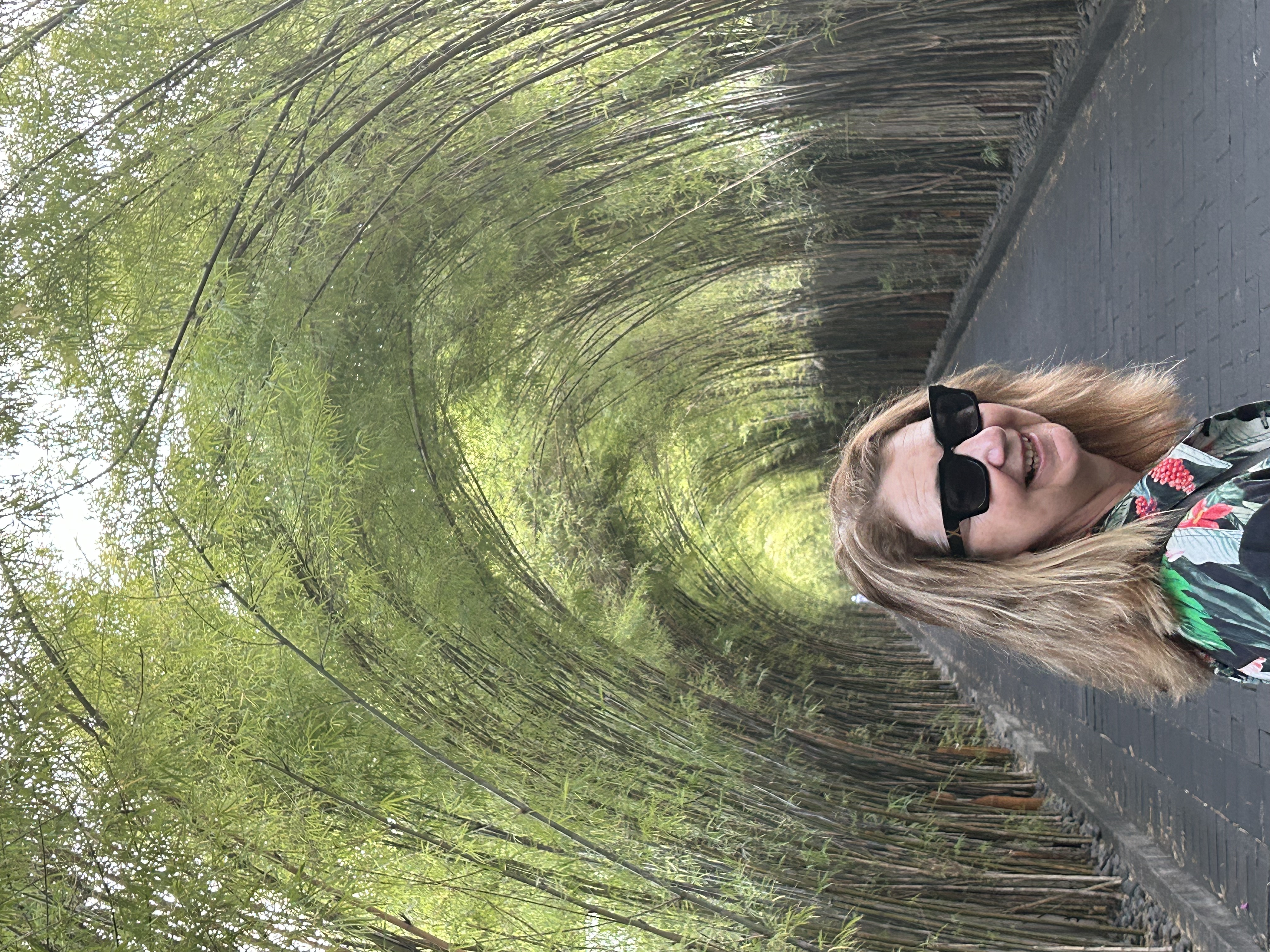 Woman smiling in bamboo tunnel