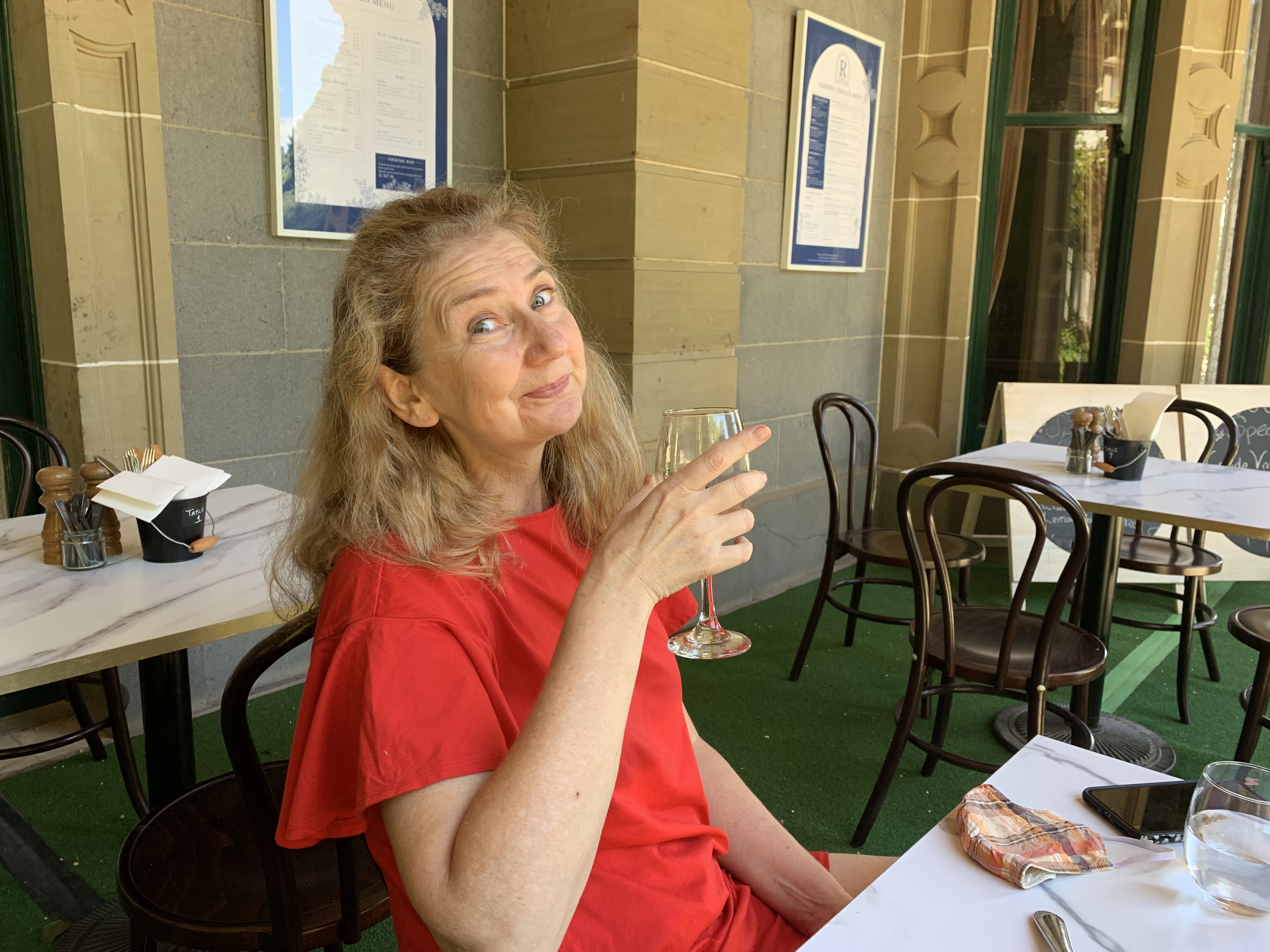 Woman enjoying wine at outdoor café